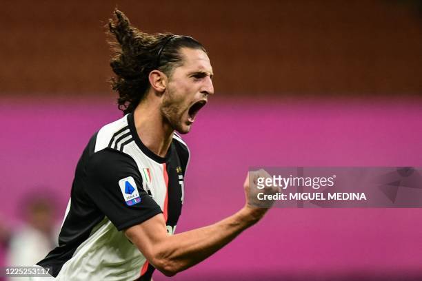 Juventus' French midfielder Adrien Rabiot celebrates after opening the scoring during the Italian Serie A football match AC Milan vs Juventus played...