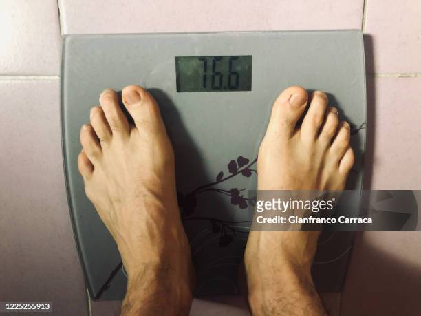 the ritual of weighing yourself on a scale every day - animal body part stock pictures, royalty-free photos & images