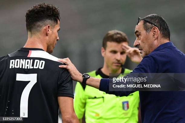 Juventus' Italian coach Maurizio Sarri talks to Juventus' Portuguese forward Cristiano Ronaldo during the Italian Serie A football match AC Milan vs...