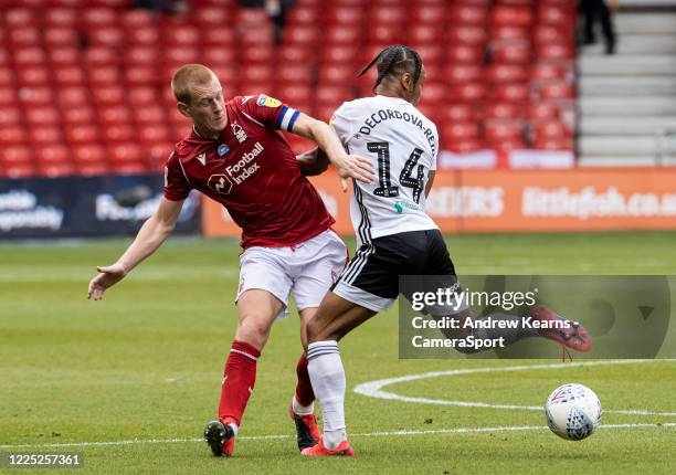 Fulham's Bobby Reid competing with Nottingham Forest's Ben Watson during the Sky Bet Championship match between Nottingham Forest and Fulham at City...