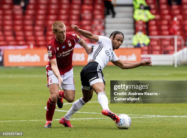 Fulham's Bobby Reid competing with Nottingham Forest's Ben Watson during the Sky Bet Championship match between Nottingham Forest and Fulham at City...