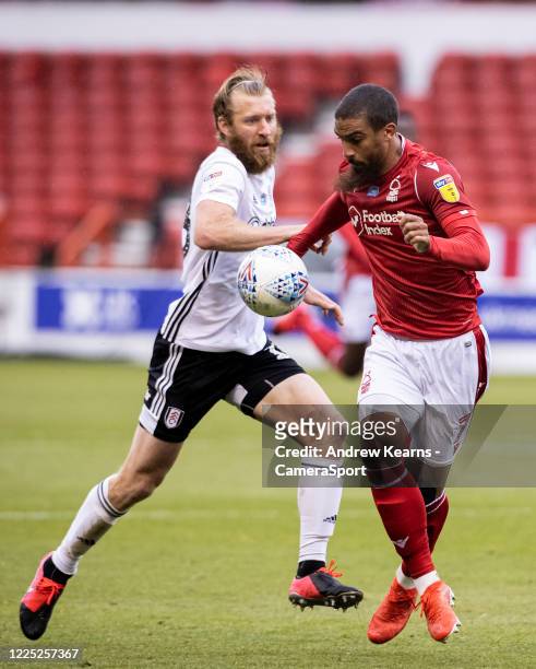 Nottingham Forest's Lewis Grabban competing with Fulham's Tim Ream during the Sky Bet Championship match between Nottingham Forest and Fulham at City...
