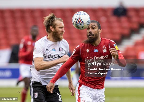 Nottingham Forest's Lewis Grabban competing with Fulham's Tim Ream during the Sky Bet Championship match between Nottingham Forest and Fulham at City...