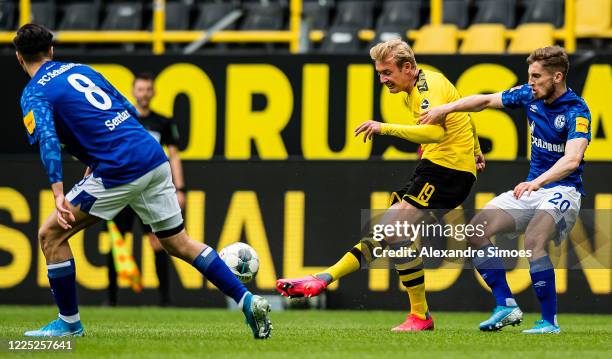 Julian Brandt (Cof Borussia Dortmund is challenged by Jonjoe Kenny of FC Schalke 04 during the Bundesliga match between Borussia Dortmund and FC...