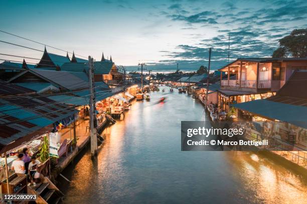 boat floating along amphawa riverside market, bangkok, thailand. - stock photo - canal stock pictures, royalty-free photos & images