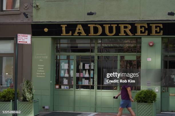 Person walks by a closed Laduree in the Soho section of manhattan during the coronavirus pandemic on May 16, 2020 in New York City. COVID-19 has...