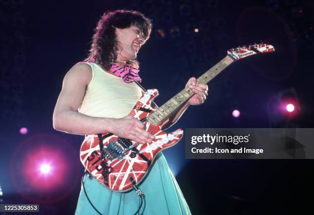 American musician, songwriter, producer, and inventor Eddie Van Halen performs at Cobo Arena during Van Halen's "Eat 'Em and Smile Tour" on September...