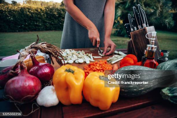 woman at home preparing vegan food - outdoor kitchen stock pictures, royalty-free photos & images