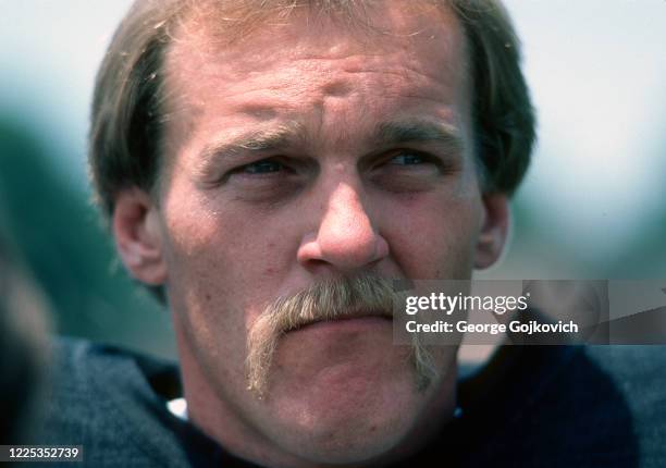 Linebacker Jack Lambert of the Pittsburgh Steelers looks on from the field during summer training camp at St. Vincent College in July 1984 in...