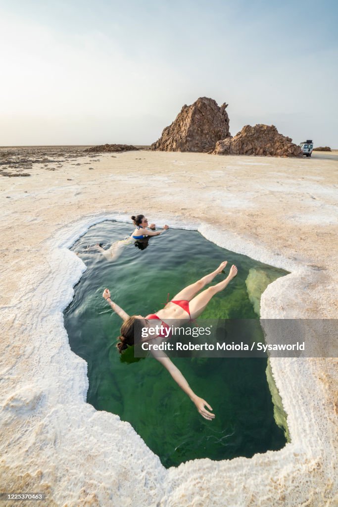 Women in bikini relaxing in a pond, Danakil Depression, Afar, Ethiopia