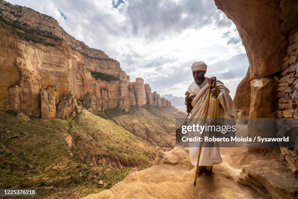 ethiopian orthodox priest holding the hand cross, abuna yemata guh church,tigray, ethiopia - abuna yemata guh church stock pictures, royalty-free photos & images