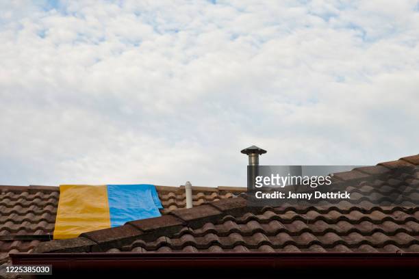 damaged roof - tarpaulin stock pictures, royalty-free photos & images