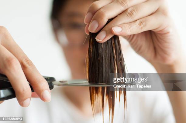 288 Young Woman Cutting Her Own Long Hair Close Up Photos and Premium High  Res Pictures - Getty Images