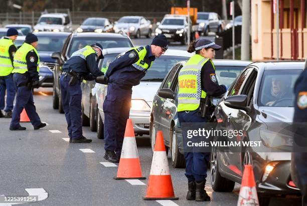 Police in the southern New South Wales border city of Albury check cars crossing the state border from Victoria on July 8, 2020 after authorities...