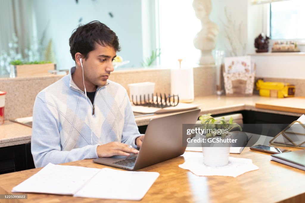 Young adult working from Home during COVID-19 Quarantine Lockdown