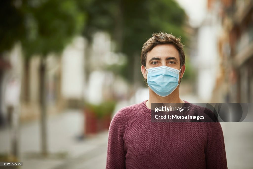 Portrait of a Man in the City Wearing Protective Face Mask