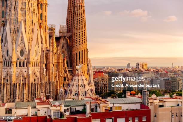 sagrada familia and barcelona cityscape at sunset, catalonia, spain - sagrada familia foto e immagini stock