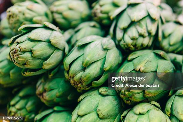 close-up of fresh artichokes - artichoke stock pictures, royalty-free photos & images