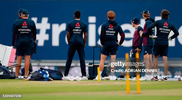 England's head coach Chris Silverwood and his players wear jumpers bearing the names of cricket-playing keyworkers and staff of Britain's NHS who...