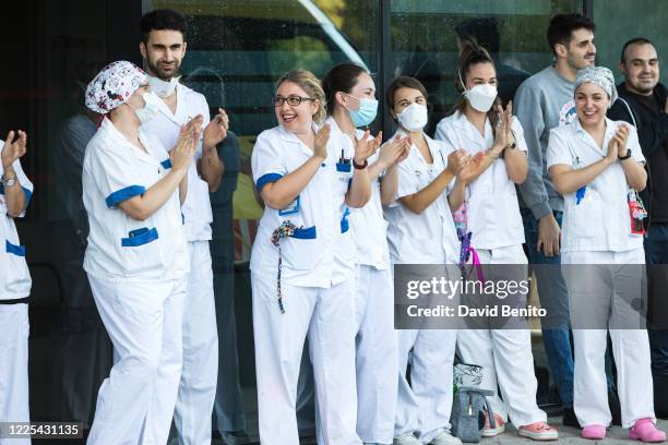 Sanitary personal of Villalba General Hospital are seen at the Emergency entrance while local police, Civil protection and firefighters applaud them...