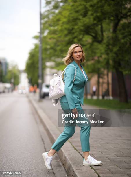 Veronica Ferres wearing Drykorn suit, Furla bag and Veja sneaker on May 13, 2020 in Munich, Germany.