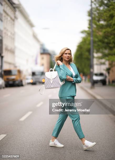 Veronica Ferres wearing Drykorn suit, Furla bag and Veja sneaker on May 13, 2020 in Munich, Germany.
