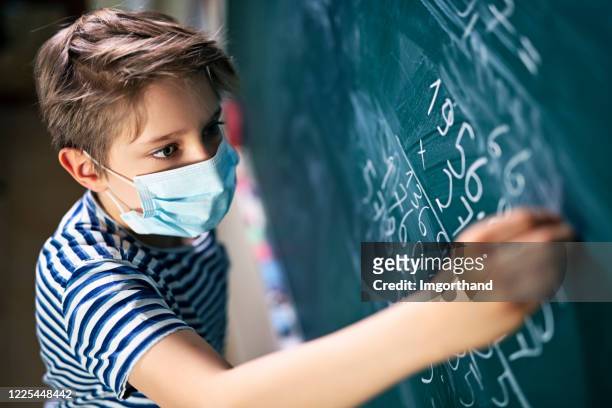 cute little boy on math lesson during covid-19 pandemic - mathematics stock pictures, royalty-free photos & images