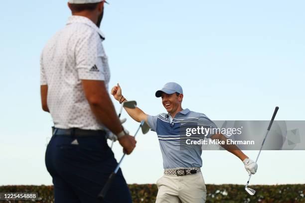 Rory McIlroy of the American Nurses Foundation team and Dustin Johnson of the American Nurses Foundation team react on the 17th tee after winning the...