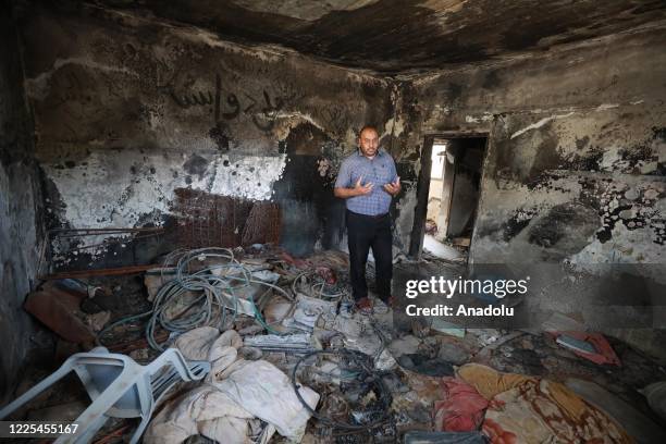 Palestinian man shows around at the house of Dawabsheh family burnt down during an arson attack by a group of Israeli Jewish settlers to Duma...