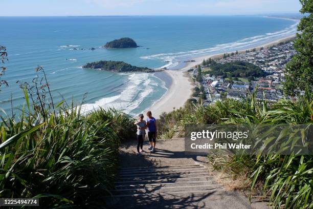 People walk up Mount Maunganui after it was reopened to people following the move to Level 2 on May 18, 2020 in Tauranga, New Zealand. New Zealand...