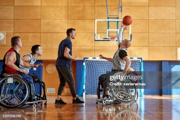 jump ball in wheelchair basketball practice game - wheelchair basketball team stock pictures, royalty-free photos & images