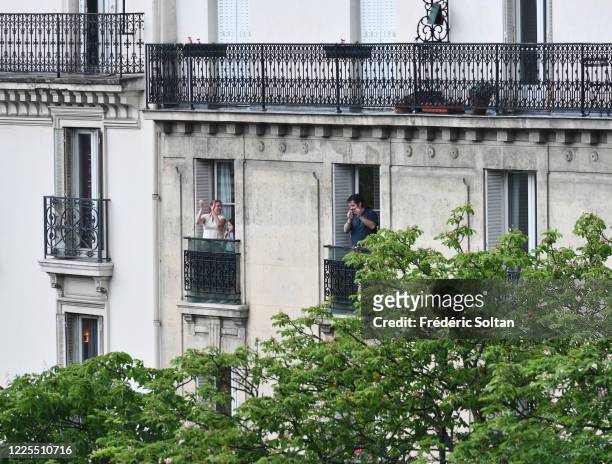 People applaud on their balcony at the neighborhood of "Gobelins" during the confinement of the French due to an outbreak of the coronavirus on May...