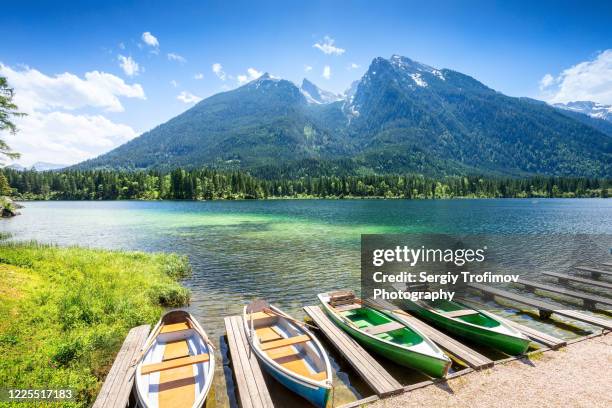 boats on mountain lake in summer day - berchtesgaden stock-fotos und bilder