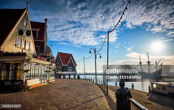 volendam, the netherlands with a merchant ship in the background - ijsselmeer stock pictures, royalty-free photos & images