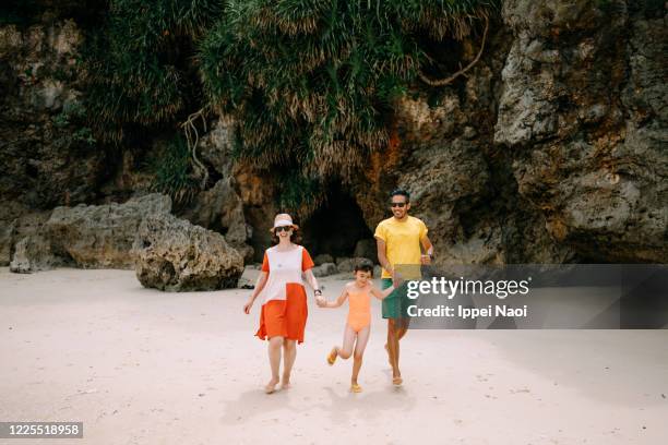 family running on tropical beach, okinawa, japan - eurasian ethnicity stock pictures, royalty-free photos & images