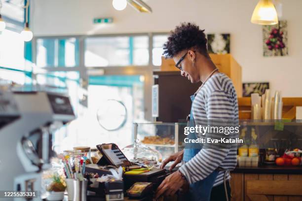 young barista is working in a café - first job stock pictures, royalty-free photos & images