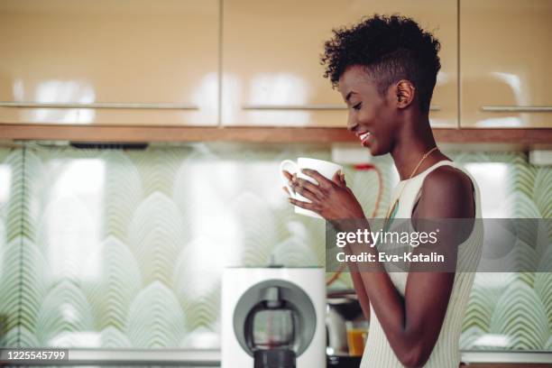 young woman at home - coffee machine home stock pictures, royalty-free photos & images