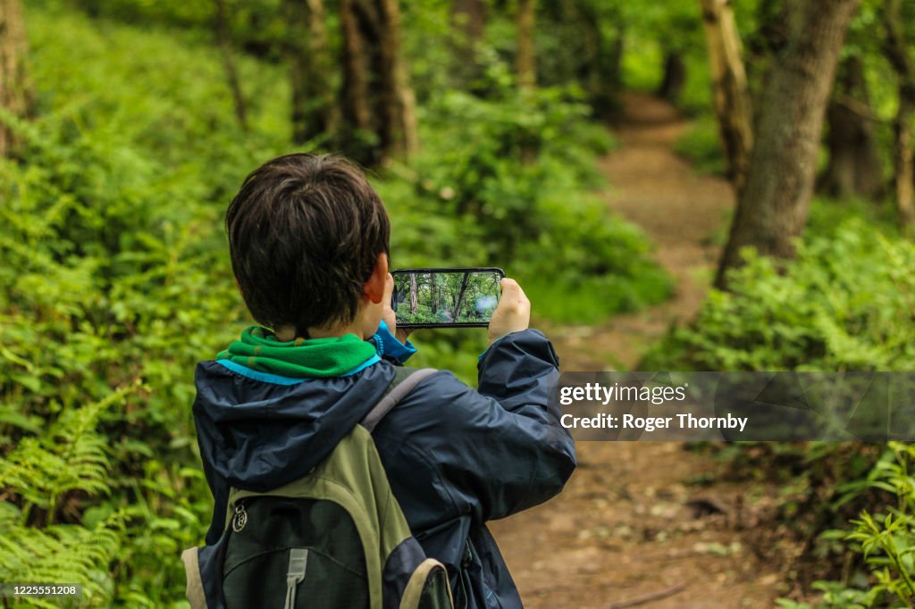 A child taking photos on a country footpath