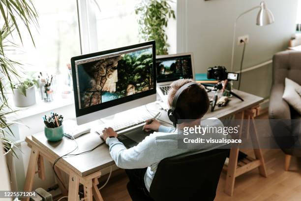 digital artist drawing on digital surface while video podcasting from home studio - home office ergonomics stock pictures, royalty-free photos & images