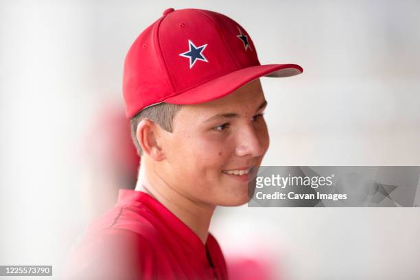 close-up portrait of teen baseball player in red cap and uniform - all star portraits stock pictures, royalty-free photos & images