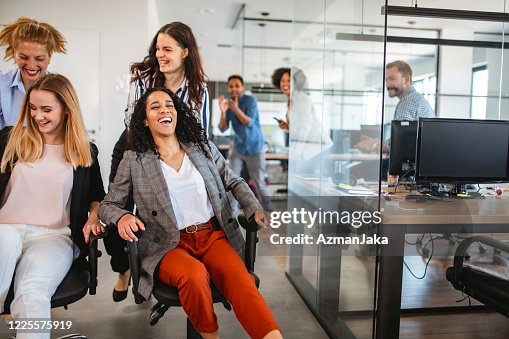 Playful Young Businesswomen Laughing And Having Fun At Work High-Res ...