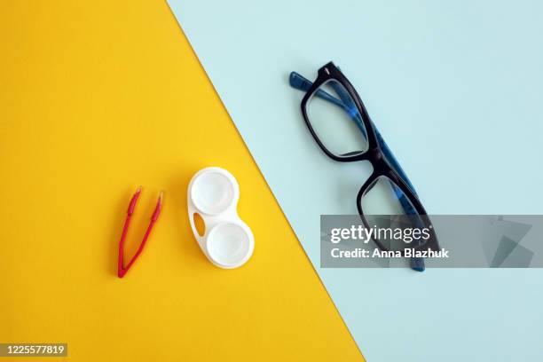colorful flat lay comparison of eyeglasses and contact lenses - contact lens stock pictures, royalty-free photos & images