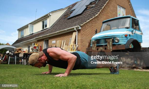 Tom Wood, the Northampton Saints and England back row forward, does pushups as he works out in his garden on May 18, 2020 in Northampton, United...