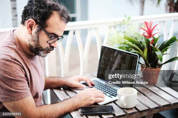 mature brazilian man working from home - job search stress stock pictures, royalty-free photos & images