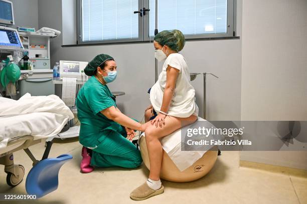 Mamma Sara assisted by the midwife during the labor of natural childbirth in the gynaecology department of the San Marco hospital in Catania on May...