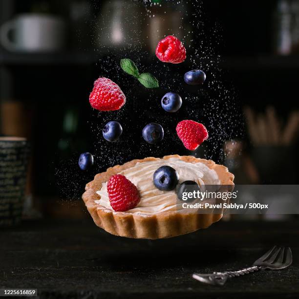 shot of falling tart and levitating ingredients, paris, france, ile-de-france - obsttorte stock-fotos und bilder