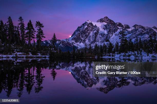 moon rising over snow capped mountain with forest and lake, peaceful valley, whatcom county, washington, usa - lake whatcom bildbanksfoton och bilder