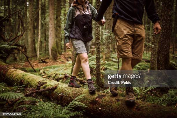 couple of hikers on their adventure in forest - hiking boot stock pictures, royalty-free photos & images