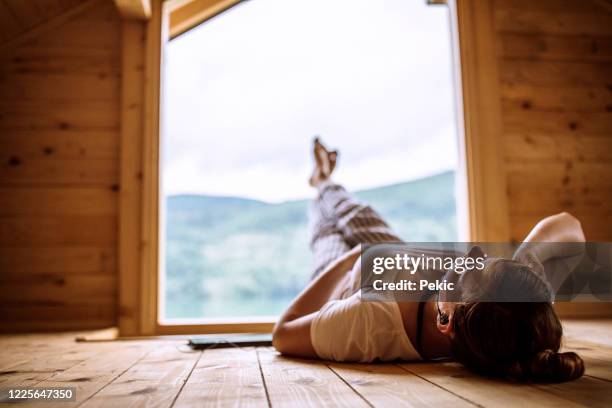 inhaling every second of peaceful scene - hut interior stock pictures, royalty-free photos & images