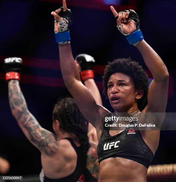 Angela Hill of the United States and Claudia Gadelha of Brazil react in their Women's Strawweight bout during UFC Fight Night at VyStar Veterans...
